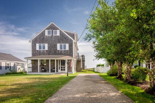 a house with a driveway leading up to it at 53 Freeman Avenue Sandwich - Cape Cod in Sandwich