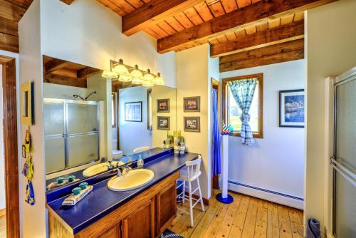 a bathroom with a sink and a large mirror at 53 Freeman Avenue Sandwich - Cape Cod in Sandwich