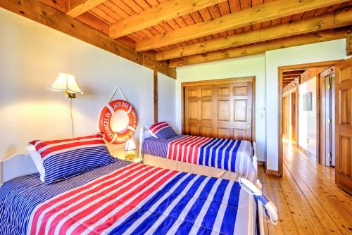two beds in a room with wooden ceilings at 53 Freeman Avenue Sandwich - Cape Cod in Sandwich