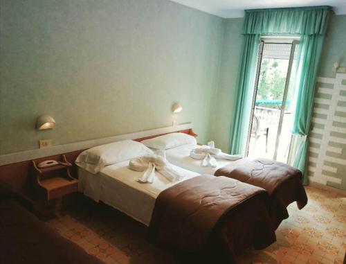 En eller flere senge i et værelse på Hotel Elvira Fiuggi