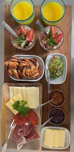 a table with several plates of food on it at Rosenhøj Bed and Breakfast in Svendborg