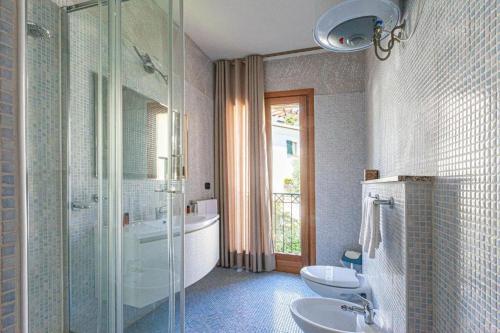 a bathroom with two sinks and a shower and a tub at Appartamenti Le Maree in La Maddalena