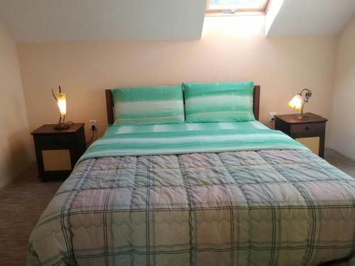 a bedroom with a large bed with two night stands at Krystyna in Bystre