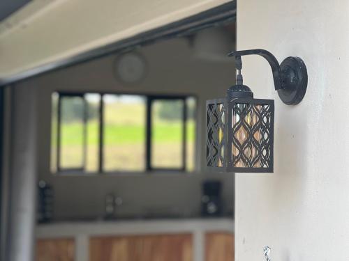 a light hanging on the side of a wall at Rosetta Fields Country Lodge in Rosetta