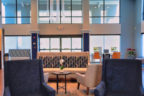 a lobby with two chairs and a couch and a table at Holiday Inn Express Hotel & Suites Tampa-Oldsmar by IHG in Oldsmar