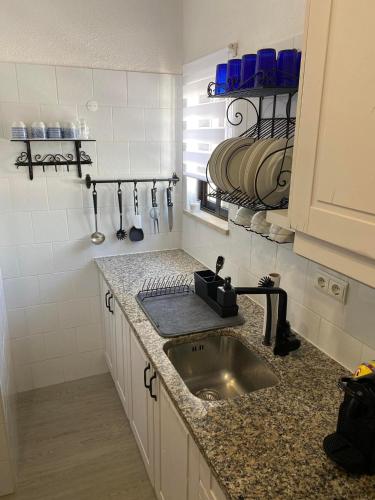 a kitchen with a sink and a counter top at Vista Mar Aldeia de Marim in Marim