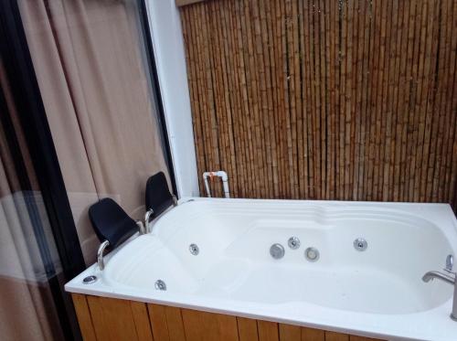 a bath tub in a bathroom with a shower at Glamping Barichara in Barichara