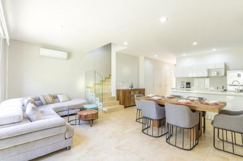 a living room with a couch and a table at Ciudad Mayakoba Homes by Vimex in Playa del Carmen