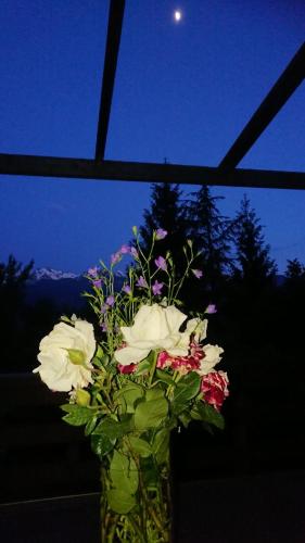 a vase filled with flowers sitting on a table at Casa delle Rose in Teglio