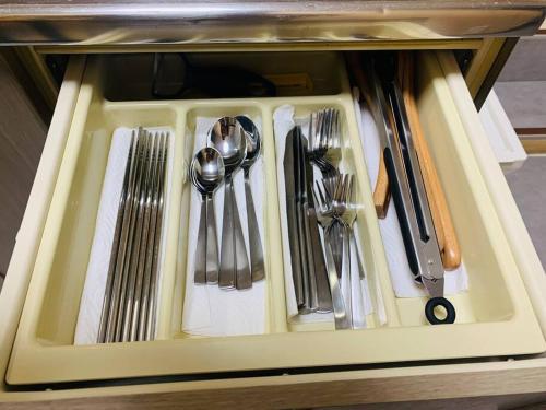 a tray filled with utensils in a drawer at MoRi House IN 伊勢佐木町 in Yokohama