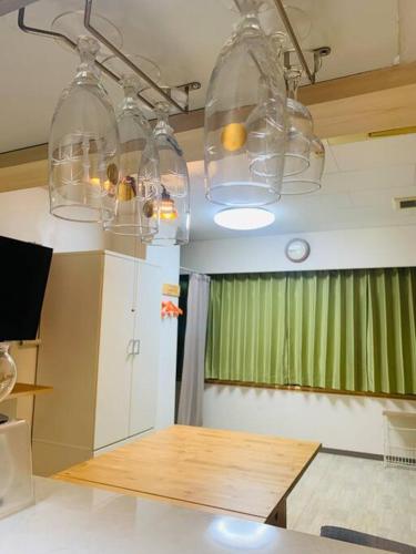 a kitchen with two lights and a wooden table at MoRi House IN 伊勢佐木町 in Yokohama