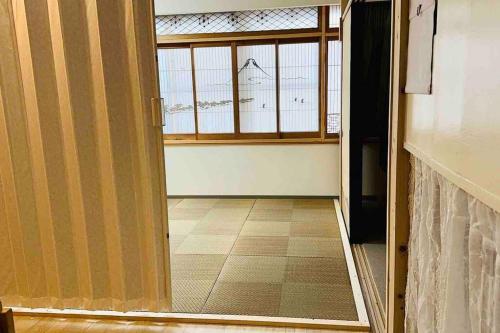 an open door to a room with a window at MoRi House IN 伊勢佐木町 in Yokohama