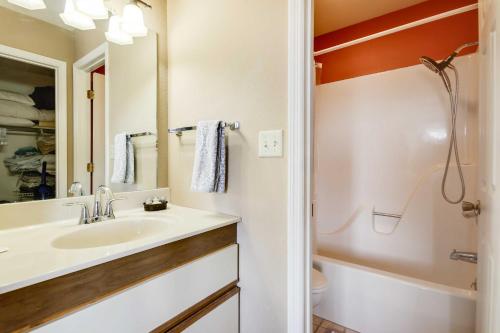 een badkamer met een wastafel, een toilet en een spiegel bij Osage Beach Condo with Pools, Marina and Grill! in Osage Beach