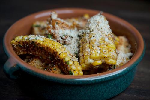a bowl of food with corn on the cob at Hotel Commonwealth in Boston
