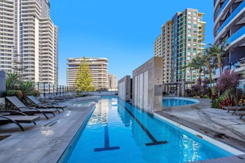 a swimming pool in a city with tall buildings at 29th floor Oracle Tower 2 stunning ocean and city views in Gold Coast