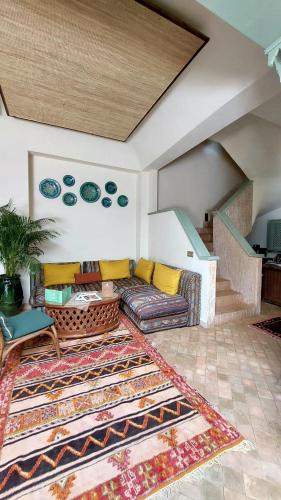 a living room with a couch and a rug at Riad Lalla Mimouna in Marrakech