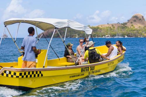 a group of people on a yellow boat in the water at Bay Gardens Beach Resort & Spa in Gros Islet