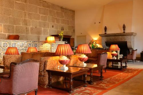 a living room with couches and tables with lamps on them at Pousada Mosteiro de Guimaraes in Guimarães