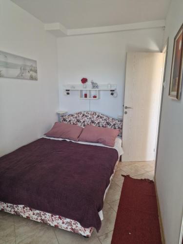 a bedroom with a large bed in a room at Marta apartment in Petrovac na Moru