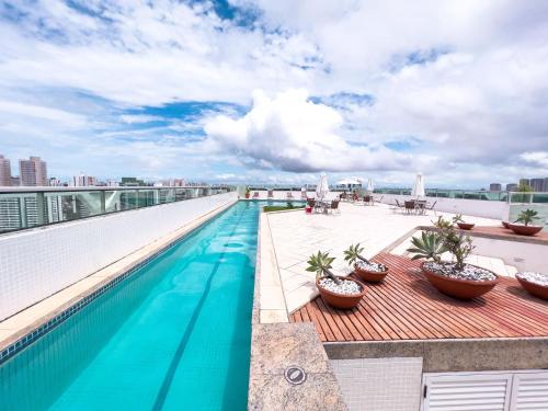 a swimming pool on the roof of a building at Iguatemi Business & Flat in Salvador