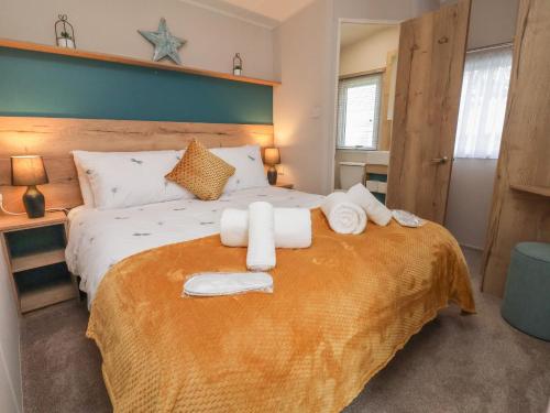 a bedroom with a large bed with towels on it at Walkers Retreat in Ganton