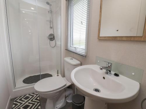 a bathroom with a sink and a toilet and a shower at Walkers Retreat in Ganton