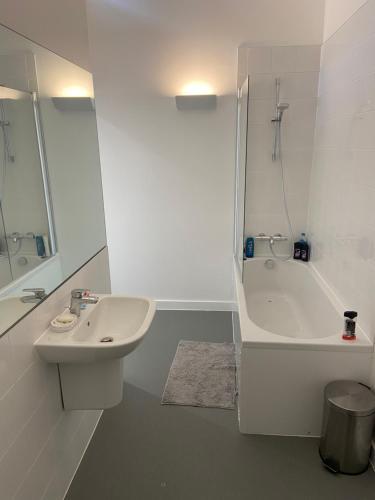 a white bathroom with a sink and a bath tub at Shared with Host Lister Pods Executive Penthouse in Bradford