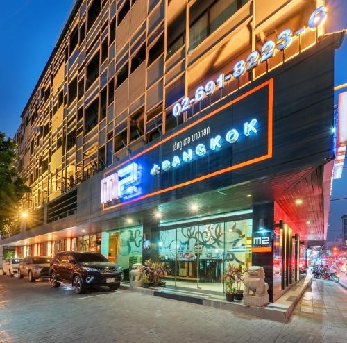 a building with a sign on the side of it at M2 de Bangkok Hotel in Bangkok