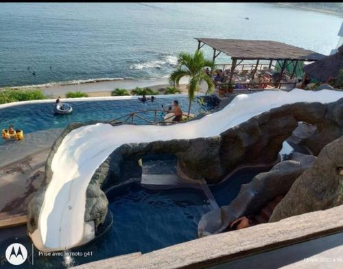 a water slide at a resort next to the ocean at Villa del Palmar departemento in Manzanillo