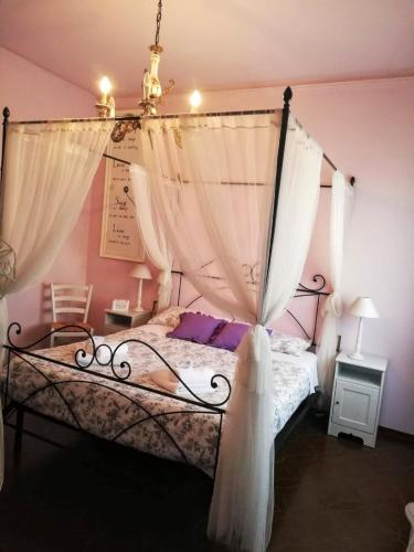 a bedroom with a bed with a canopy at B&B Le Mi' Cocche in Capannori
