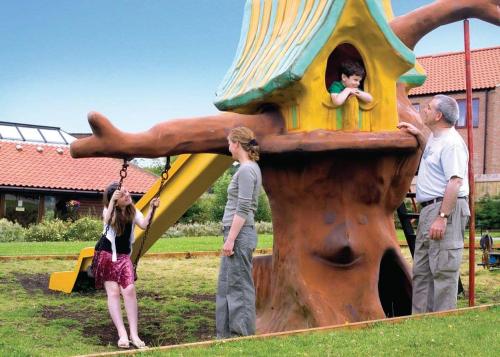 a group of children playing on a playground at Captain Cooks Haven in Whitby