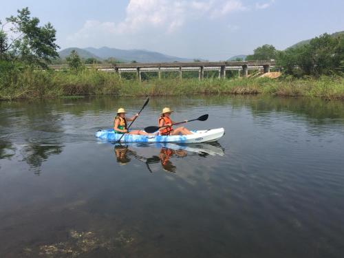 two people in a kayak on a river at Hello countryside in Ban Khang Hong Tai