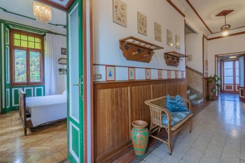 a bedroom with a bed and a chair in a room at Family Villa with Stunning Lake View by Wonderful Italy in Civenna