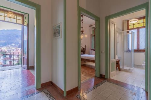 a hallway with green walls and a room with a view at Family Villa with Stunning Lake View by Wonderful Italy in Civenna