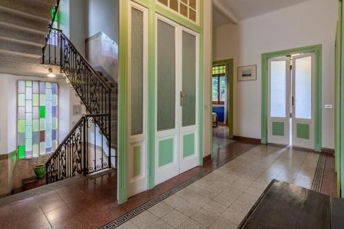 a hallway with a staircase and glass doors in a house at Family Villa with Stunning Lake View by Wonderful Italy in Civenna