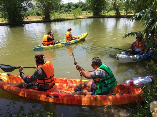 a group of people in kayaks on a river at Hello countryside in Ban Khang Hong Tai