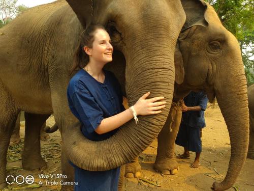 a woman is standing next to an elephant at Hello countryside in Ban Khang Hong Tai