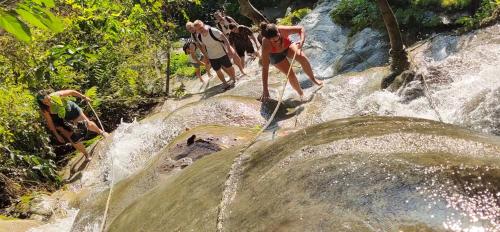 a group of people playing in a waterfall at Hello countryside in Ban Khang Hong Tai