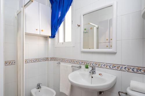 a white bathroom with a sink and a mirror at Fuengirola old town accomodation Ref 134 in Fuengirola