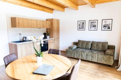 a living room with a wooden table and a couch at Gasthof Fischerwirt in Zeutschach