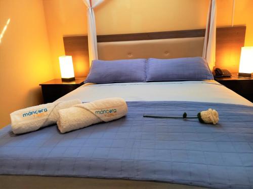 a bedroom with a bed with two towels on it at Mancora y Sol in Máncora