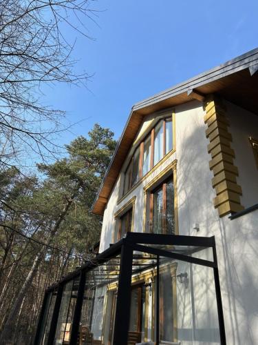 a glass house with trees in the background at Leśna Residence & SPA in Pisz