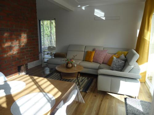 a living room with a couch and a table at Kustverhuur, Park Schoneveld, Zeester 49 in Breskens