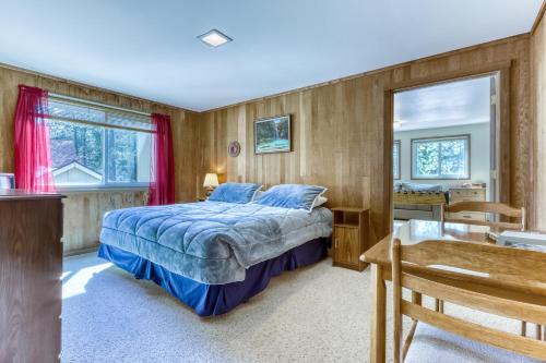 a bedroom with a bed and a desk and a sink at Mt View Lane 7 | Discover Sunriver in Sunriver