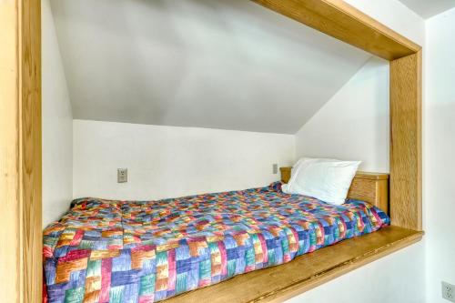 a bed with a colorful bedspread in a room at Mt View Lane 7 | Discover Sunriver in Sunriver