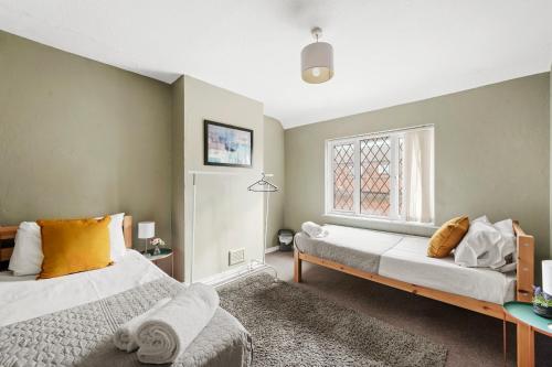 a bedroom with two beds and a window at Beautiful 4 Bed in Kent - Parking - Sleeps 7 in Kent