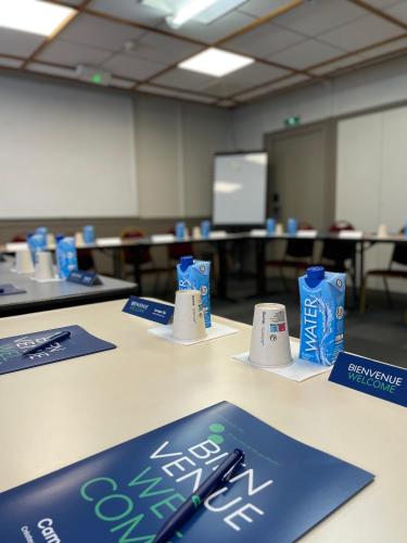 a table with blue and white signs on it at Campanile Blanc-Mesnil in Le Blanc-Mesnil