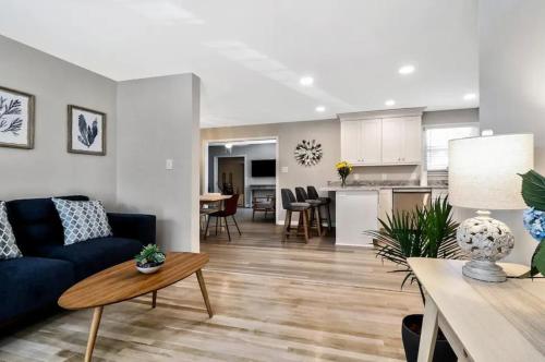 a living room with a blue couch and a kitchen at Rejuvenation and Relaxation in Virginia Beach