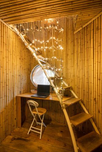 a room with a desk with a laptop and a chair at Cocohut Hoi An Homestay in Hoi An