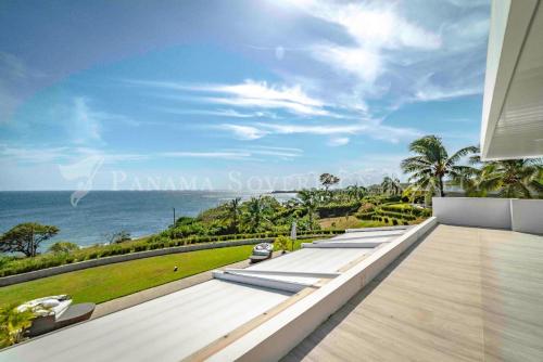 a view of the ocean from the balcony of a house at Ocean Breeze Cove - Luxury Retreat in Pedasí Town
